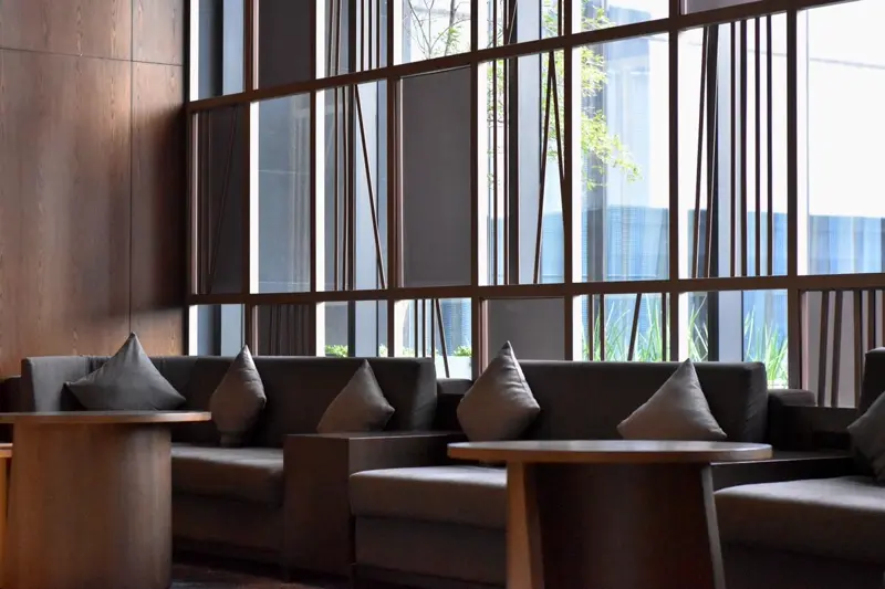 Dark contract-grade sofas in a modern hotel lounge